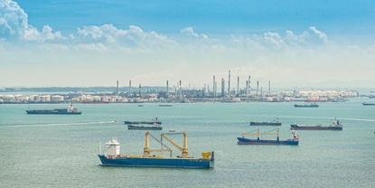 A port with various ships and bunker tankers